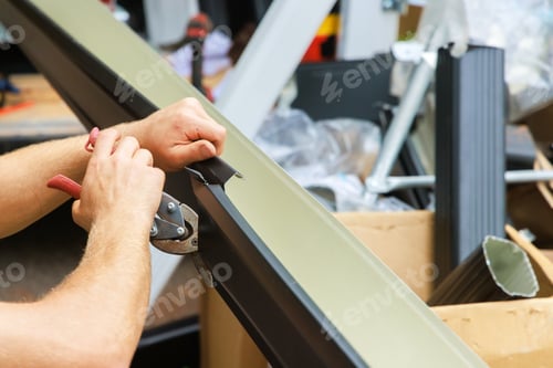Preview: Aluminum rain gutters have been bent by a machine tool then cut with shears to required size