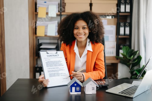 Preview: Young real estate agent worker working with laptop and tablet at table in office and small