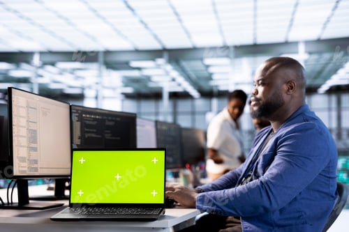 Preview: IT professional using chroma key notebook to look for errors