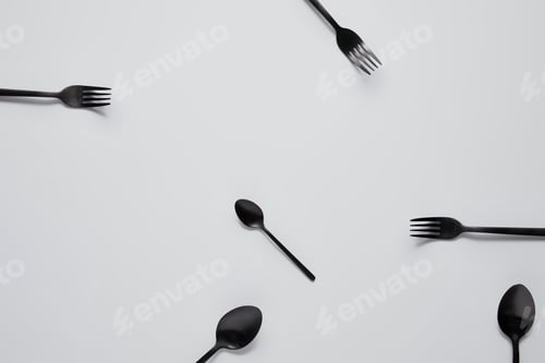 Preview: top view of various black spoons and forks on white table