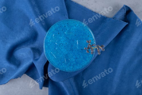 Preview: Fresh homemade blue cocktail on blue background