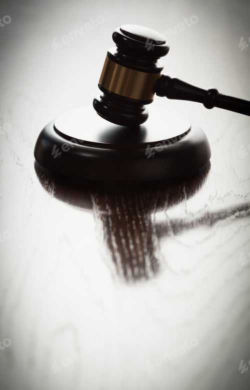 Preview: Dramatic Gavel Silhouette on Reflective Wood Surface.