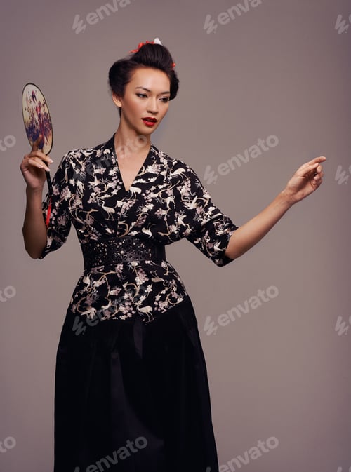 Preview: Studio shot of an attractive young woman dressed in traditional asian clothing