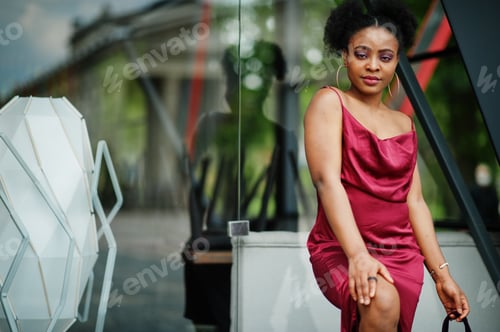 Preview: Black model in red silk dress.