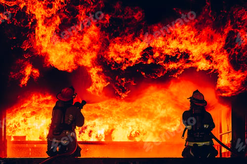 Preview: Fearless Firefighters Battling Blaze with Water and Extinguishers.