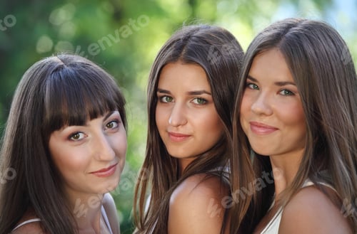 Preview: Beautiful young girls in green summer park