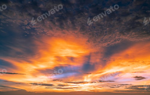 Preview: Beautiful sunset sky. Golden and orange sky and clouds with sunbeam. God light concept. Nature