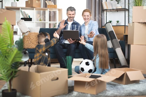 Preview: Mother and father sitting on sofa and waving hands to their kids on the floor