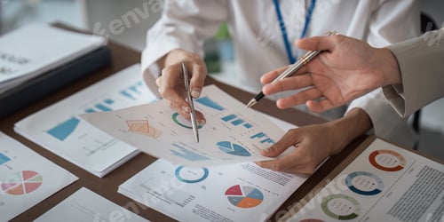 Preview: Businesswomen analyzing financial data and charts with calculator in office meeting