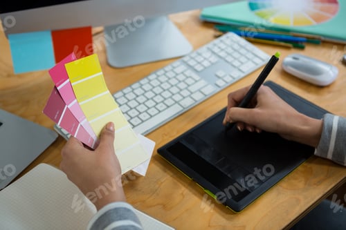 Preview: Female graphic designer working at desk