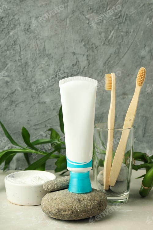 Preview: Concept of tooth or oral care against gray textured background