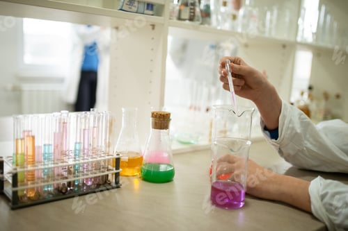 Preview: Hands doing research in a chemical laboratory