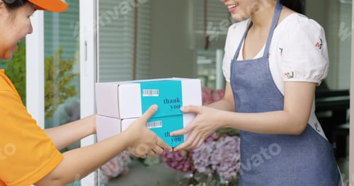 Preview: Asia people SME owner carrying parcel carton box on hand send product on site