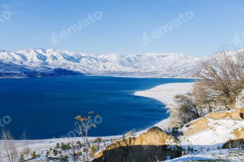 Preview: Charvak Reservoir in Winter in Uzbekistan and Lone Tree. Beautiful Winter Landscape