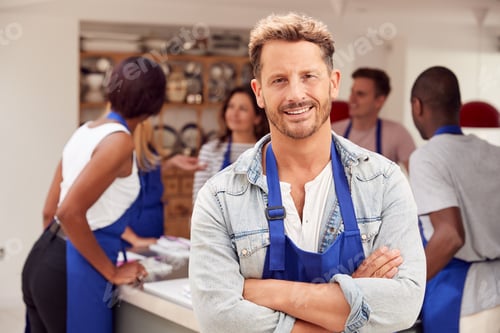 Preview: Portrait Of Smiling Mature Man Wearing Apron Taking Part In Cookery Class In Kitchen