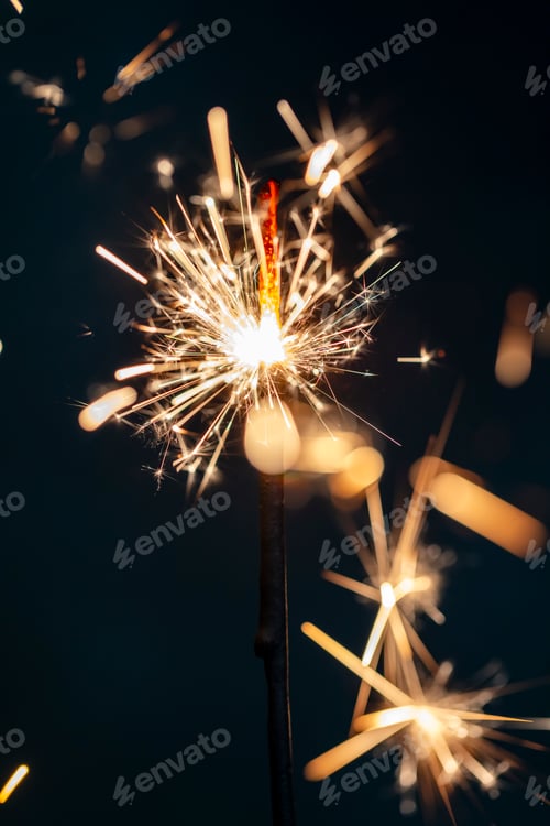 Preview: Christmas bengal fire sparkles against the black background.
