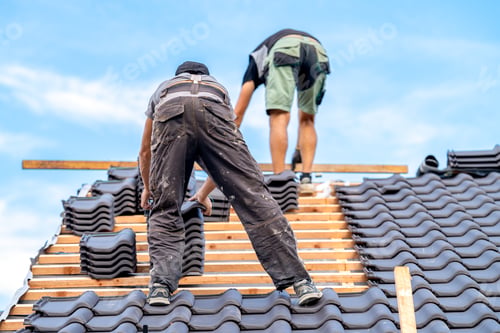 Preview: craftsmen build a new roof from ceramic tiles on wooden beams
