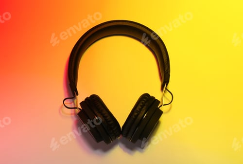 Preview: Stylish headphones on color background, top view
