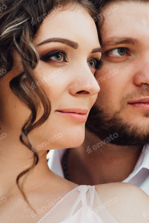 Preview: young couple a guy in black breeches and a girl in a pink dress are walking along the white sand