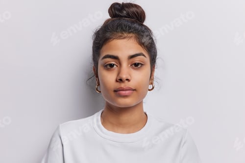 Preview: Calm Woman with Dark Hair and Gold Earrings