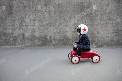 Preview: Funny businessman driving retro kids car outdoor