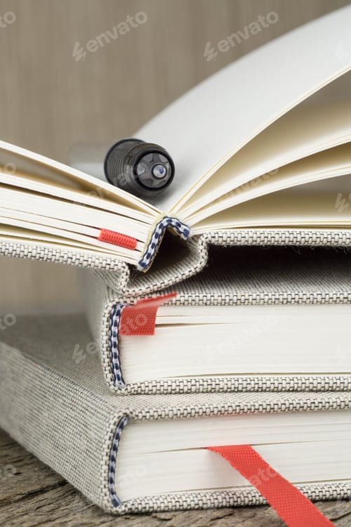 Preview: Pile of Notebooks and Pen