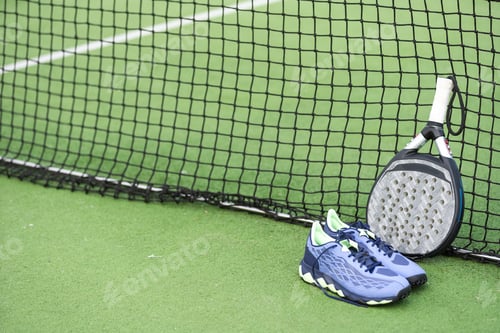 Preview: professional paddle tennis racket with natural lighting on blue background. Horizontal sport theme