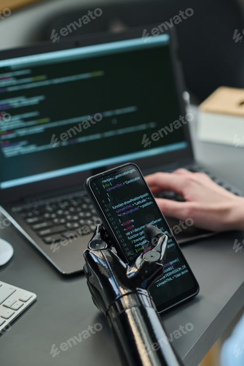 Preview: Woman with disability connecting smartphone with laptop