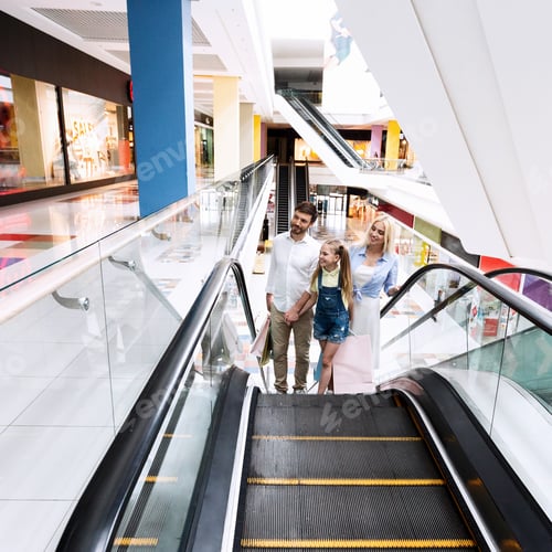 Preview: Family On Shopping Moving Up On Escalator Stairs In Hypermarket