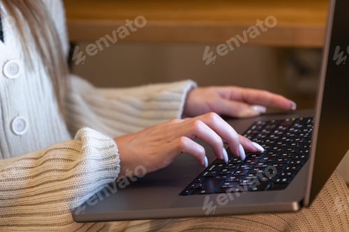 Preview: Young woman working with data on laptop closeup. Hands on keyboard.