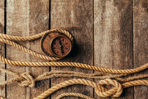 Preview: ship ropes and compass on wooden background