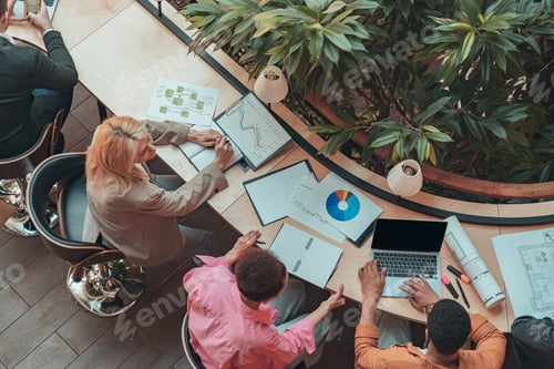 Preview: Group of coworkers working together and talking at modern office. Workplace and cooperation concept