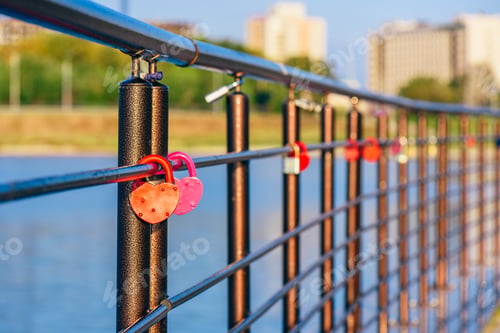 Preview: Metal locks hanging on railings.