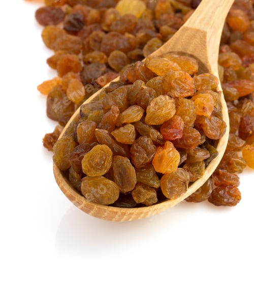 Preview: Wooden Spoon Overflowing with Golden Raisins on White