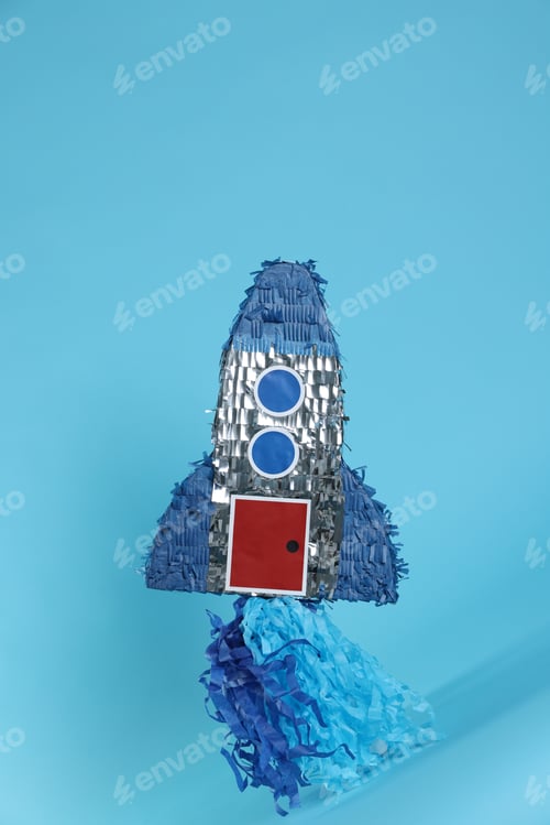 Preview: Rocket shaped pinata on light blue background