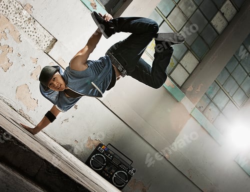 Preview: A young man breakdancing on the street of a city, doing a one handed handstand.