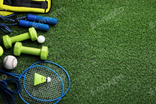 Preview: Set of different colorful sports equipment on green grass, flat lay. Space for text