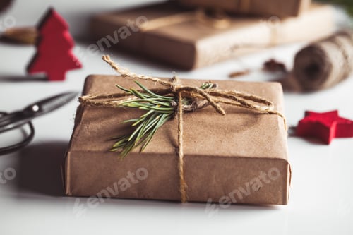 Preview: Gift in craft paper in a wreath of Christmas trees. Christmas mood, New Year, On white background