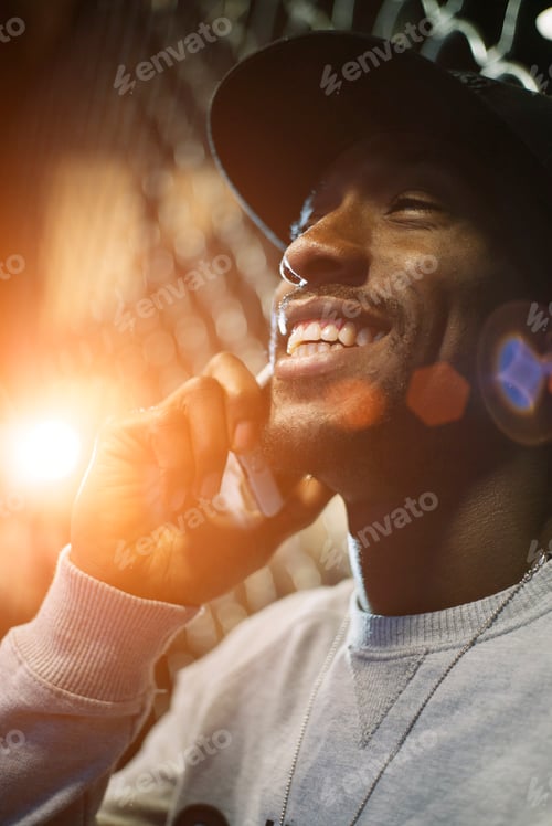 Preview: African man using mobile in the street.