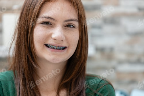Preview: Portrait of face young female caucasian beautiful woman blond hair smiling with braces.