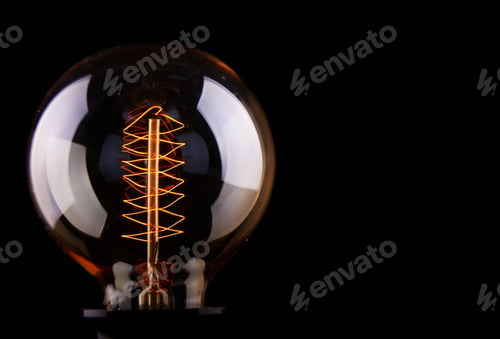 Preview: classic Edison light bulb on black background