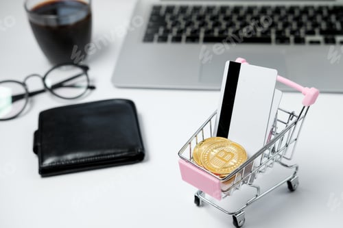 Preview: Shopping cart with Bitcoin and credit card on white desk.
