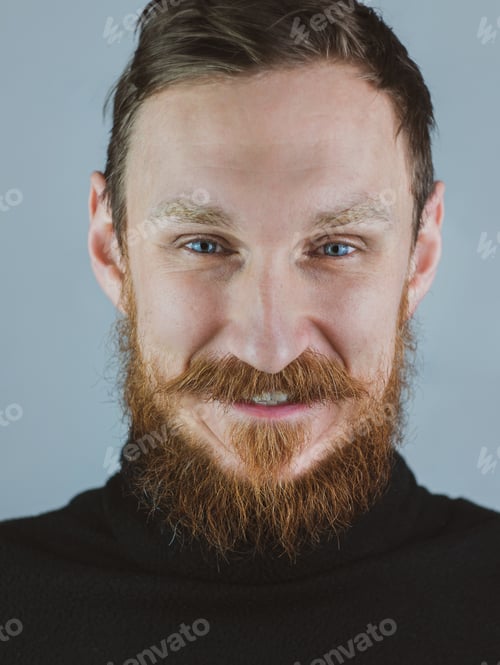 Preview: Portrait of smiling handsome bearded man looking at camera. Confident brutal hipster guy blue eyes