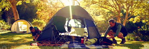 Preview: Boy setting up the tent at campsite