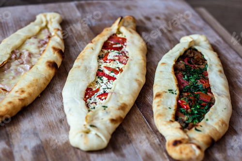 Preview: Closeup shot of delicious flatbread pockets with different fillings
