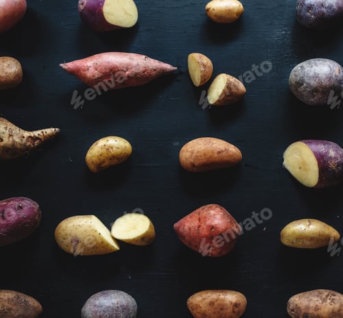 Preview: Closeup of fresh various organic potatoes on black background