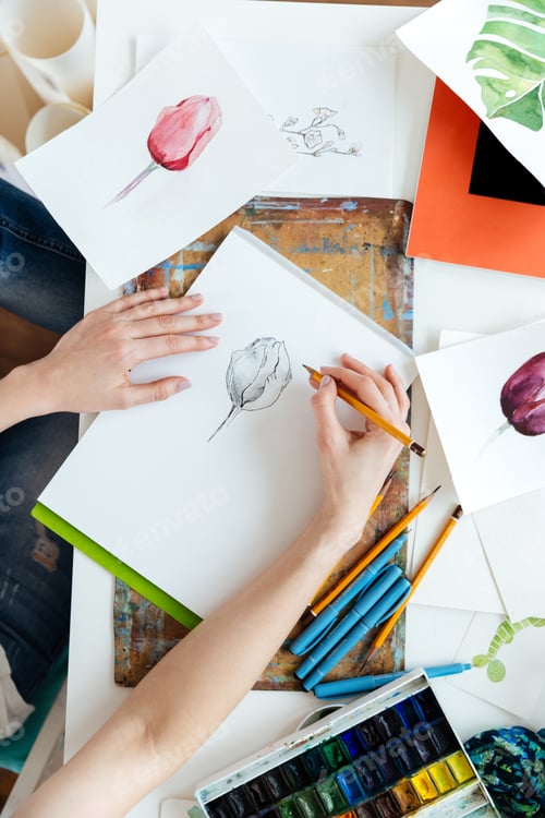 Preview: Woman painter drawing tulips by gel ink pen at table