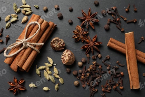 Preview: Different spices on dark gray textured table, flat lay