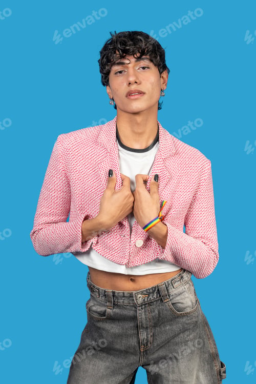 Preview: Young latin man wearing lgbt bracelet and pink jacket posing on blue background