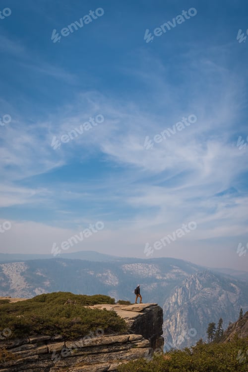 Preview: Perspective of person standing on cliff ledge of enormous landscape in Yosemite National Park